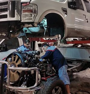 Men working on diesel truck service